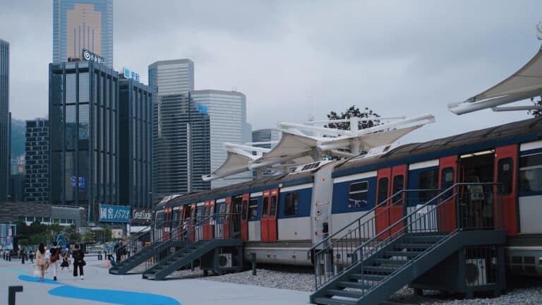 Hong Kong urban train platform with the city skyline behind it