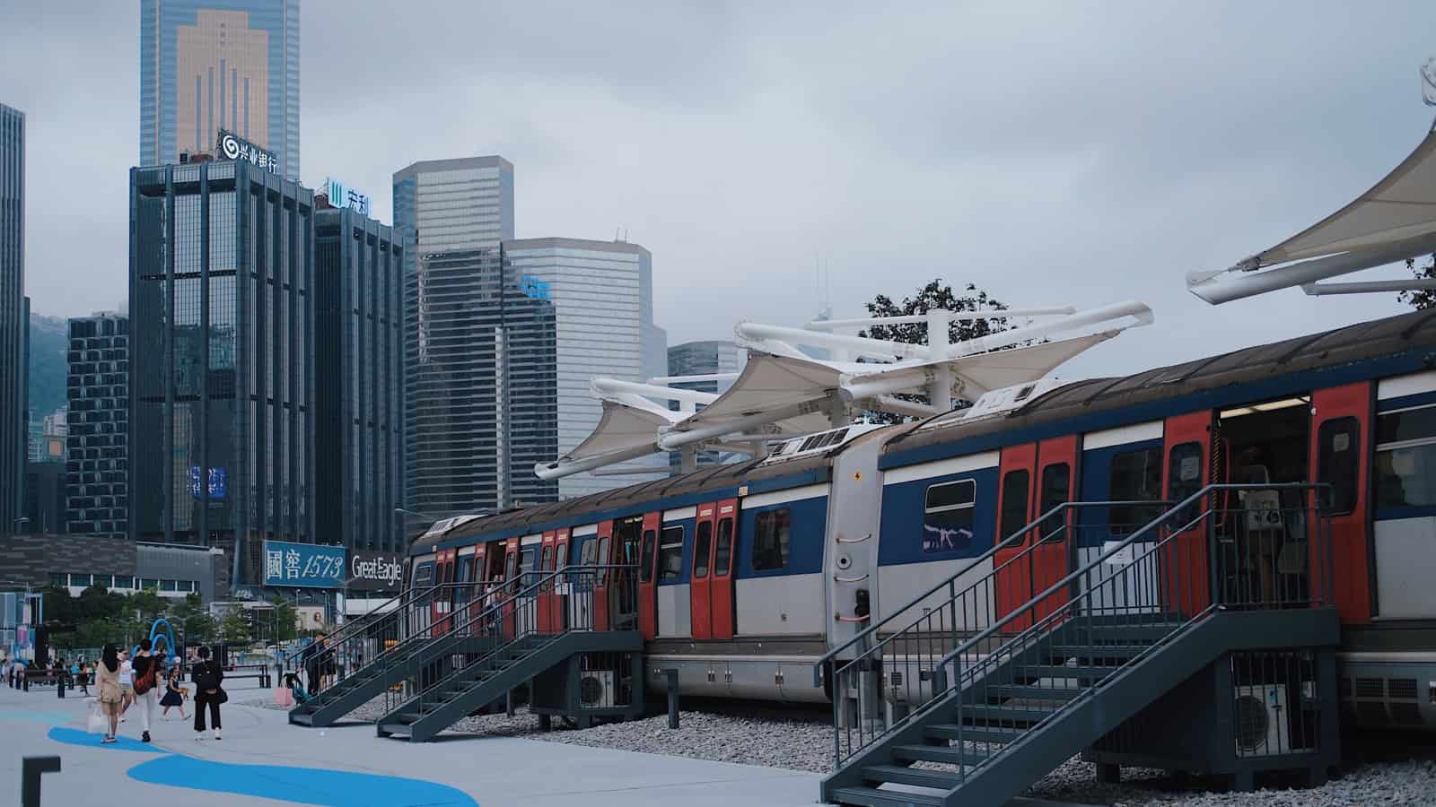 Hong Kong urban train platform with the city skyline behind it