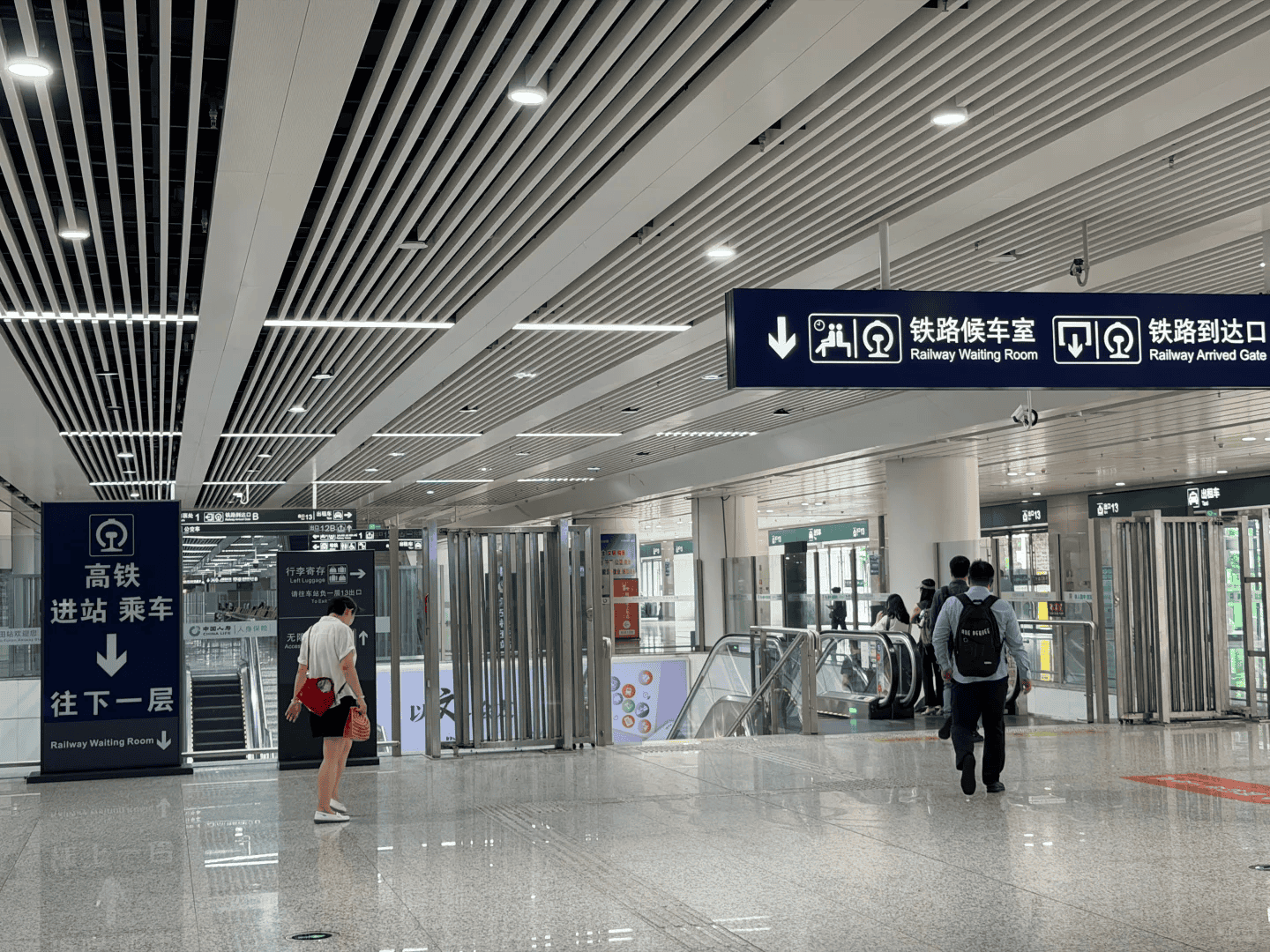 Futian Station to Hong Kong West Kowloon: Step-by-Step Guide 2 Signs leading down to the railway waiting room at Futian Station